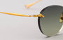 Eyepetizer Oxford C.4-52 round sunglasses for women in rimless steel, with gold frame, and green lenses. 51mm in lens size, 18mm in bridge size, and 145mm in temple length.