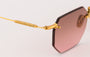 Eyepetizer Panthere C.4-44 hexagonal sunglasses for women in rimless steel, with gold frame, and green gradient lenses. 52mm in lens size, 18mm in bridge size, and 145mm in temple length.
