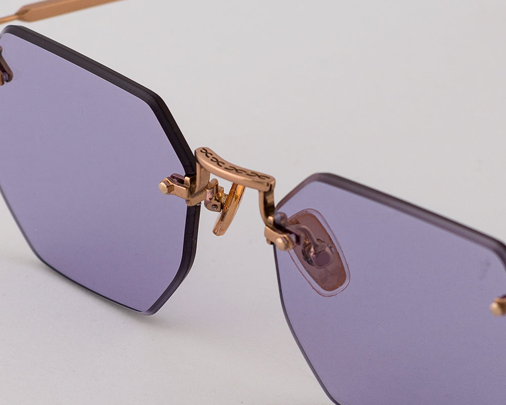 Eyepetizer Panthere C.9-49 irregular sunglasses for women in rimless steel, with rose gold frame, and violet lenses. 52mm in lens size, 18mm in bridge size, and 145mm in temple length.