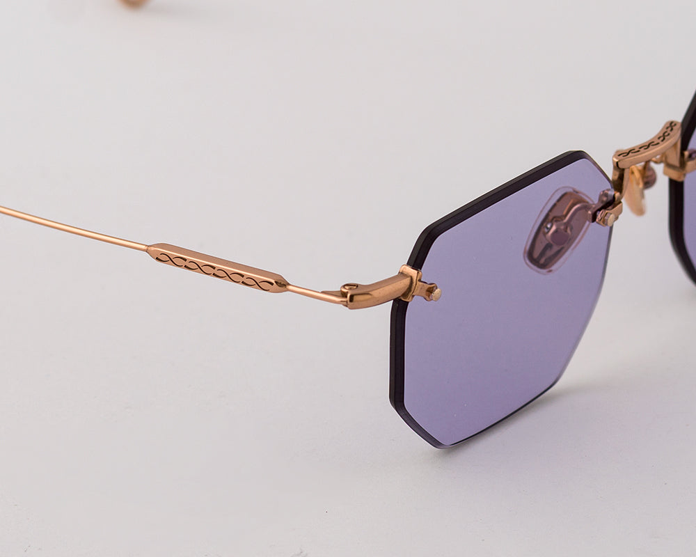 Eyepetizer Panthere C.9-49 irregular sunglasses for women in rimless steel, with rose gold frame, and violet lenses. 52mm in lens size, 18mm in bridge size, and 145mm in temple length.