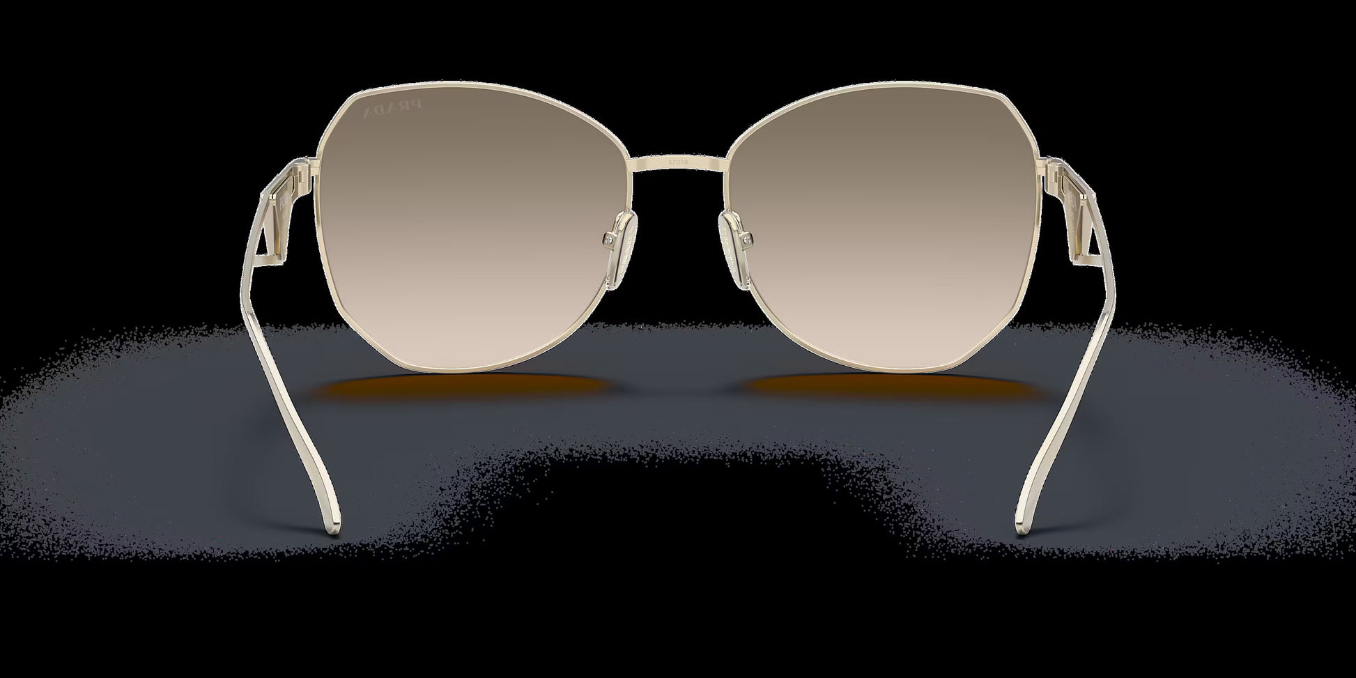 Prada PR 57YS ZVN3D0 irregular sunglasses for women in full rim metal, with pale gold frame, and light brown gradient lenses. 57mm in lens size, 18mm in bridge size, and 140mm in temple length.