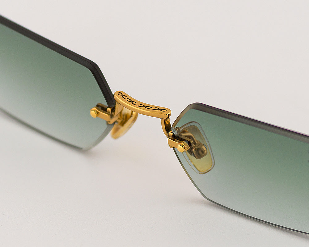 Eyepetizer Tank C.4-25 hexagonal sunglasses for women in rimless steel, with gold frame, and green gradient lenses. 52mm in lens size, 18mm in bridge size, and 145mm in temple length.