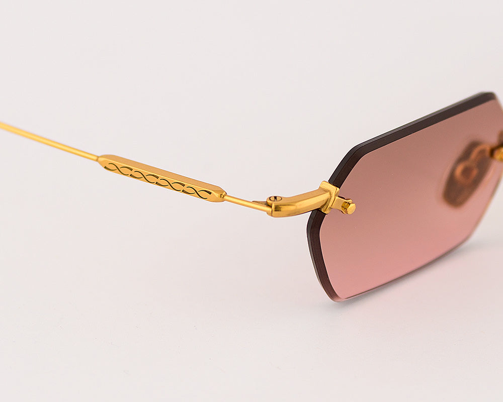 Eyepetizer Tank C.4-44 hexagonal sunglasses for women in rimless steel, with gold frame, and brown with pink gradient lenses. 52mm in lens size, 18mm in bridge size, and 145mm in temple length.