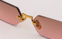Eyepetizer Tank C.4-44 hexagonal sunglasses for women in rimless steel, with gold frame, and brown with pink gradient lenses. 52mm in lens size, 18mm in bridge size, and 145mm in temple length.