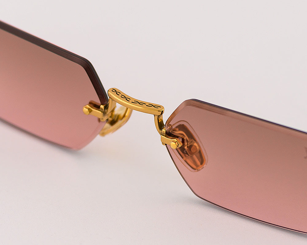 Eyepetizer Tank C.4-44 hexagonal sunglasses for women in rimless steel, with gold frame, and brown with pink gradient lenses. 52mm in lens size, 18mm in bridge size, and 145mm in temple length.