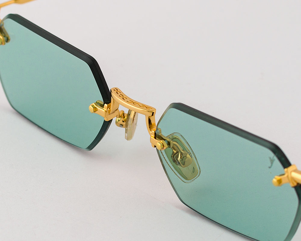 Eyepetizer Tank C.4-48 hexagonal sunglasses for women in rimless steel, with gold frame, and aqua green lenses. 52mm in lens size, 18mm in bridge size, and 145mm in temple length.
