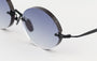 Eyepetizer Wilmot C.6-51 oval sunglasses for unisex in rimless steel, with black frame, and grey gradient lenses. 52mm in lens size, 18mm in bridge size, and 145mm in temple length.