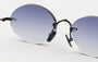 Eyepetizer Wilmot C.6-51 oval sunglasses for unisex in rimless steel, with black frame, and grey gradient lenses. 52mm in lens size, 18mm in bridge size, and 145mm in temple length.