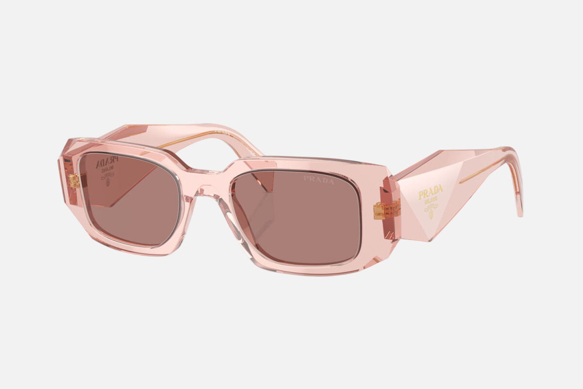 Prada PR 17WS 19Q10D rectangular sunglasses for women in full rim acetate, with transparent peach frame, and light brown lenses. 49mm in lens size, 20mm in bridge size, and 145mm in temple length.