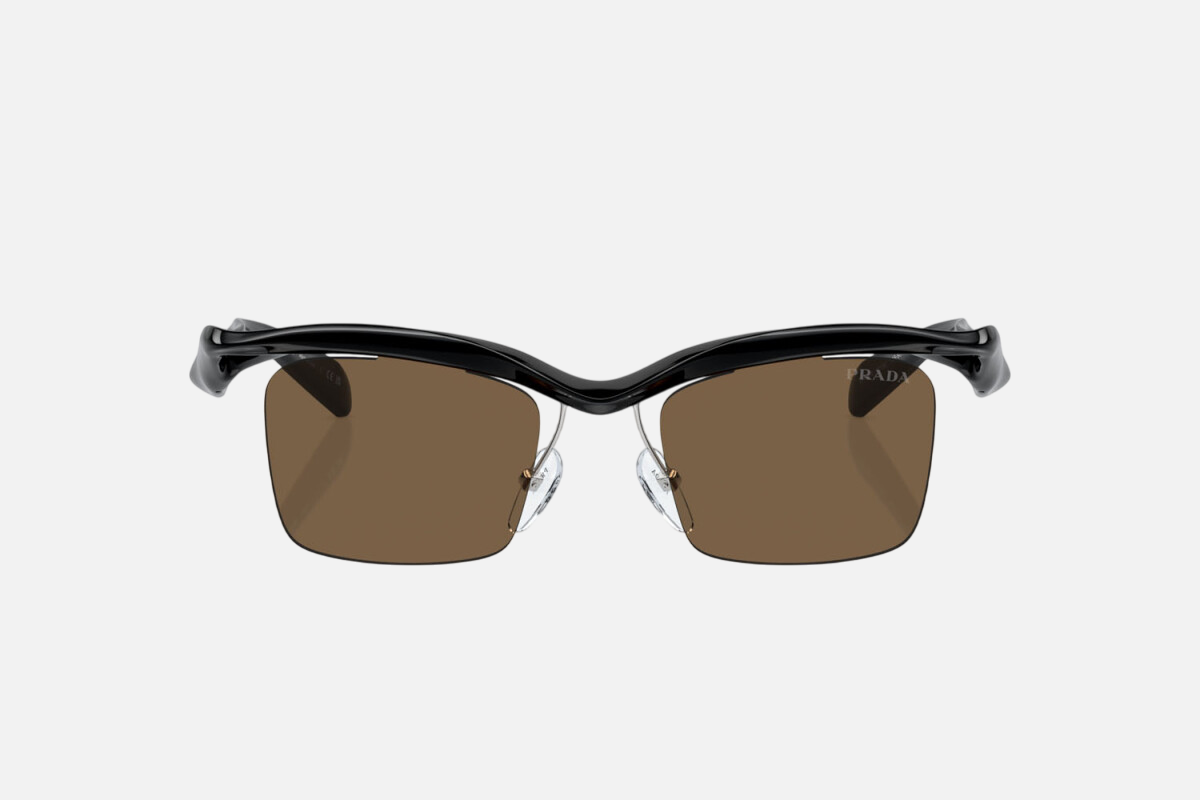 Prada PR A15S 1AB8C1 rectangular sunglasses for men in rimless nylon, with black frame, and dark brown lenses. 47mm in lens size, 20mm in bridge size, and 135mm in temple length.