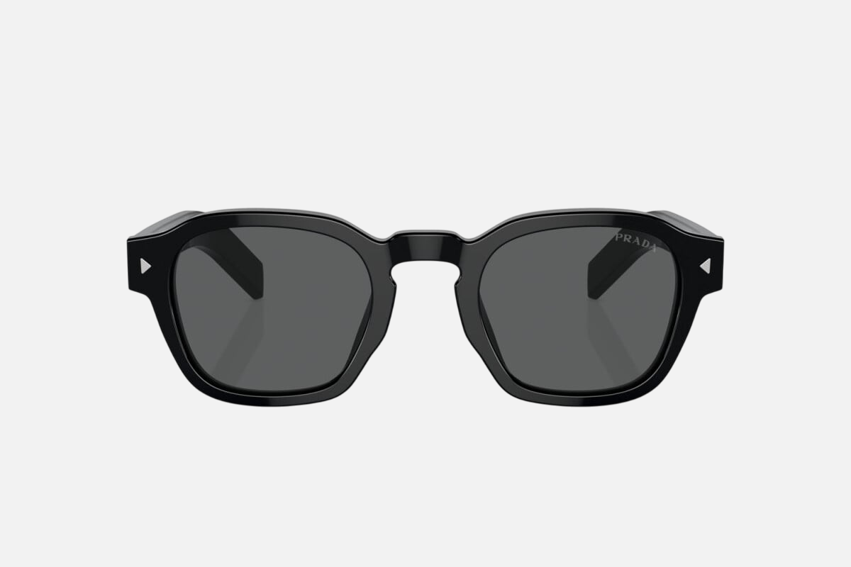 Prada PR A16S 16K731 round sunglasses for men in full rim acetate, with black frame, and dark grey lenses. 49mm in lens size, 24mm in bridge size, and 145mm in temple length.