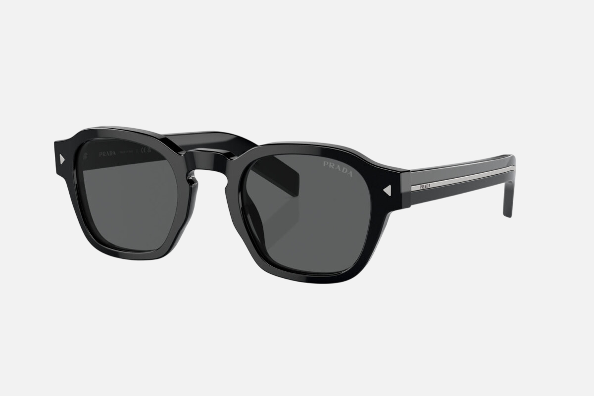Prada PR A16S 16K731 round sunglasses for men in full rim acetate, with black frame, and dark grey lenses. 49mm in lens size, 24mm in bridge size, and 145mm in temple length.