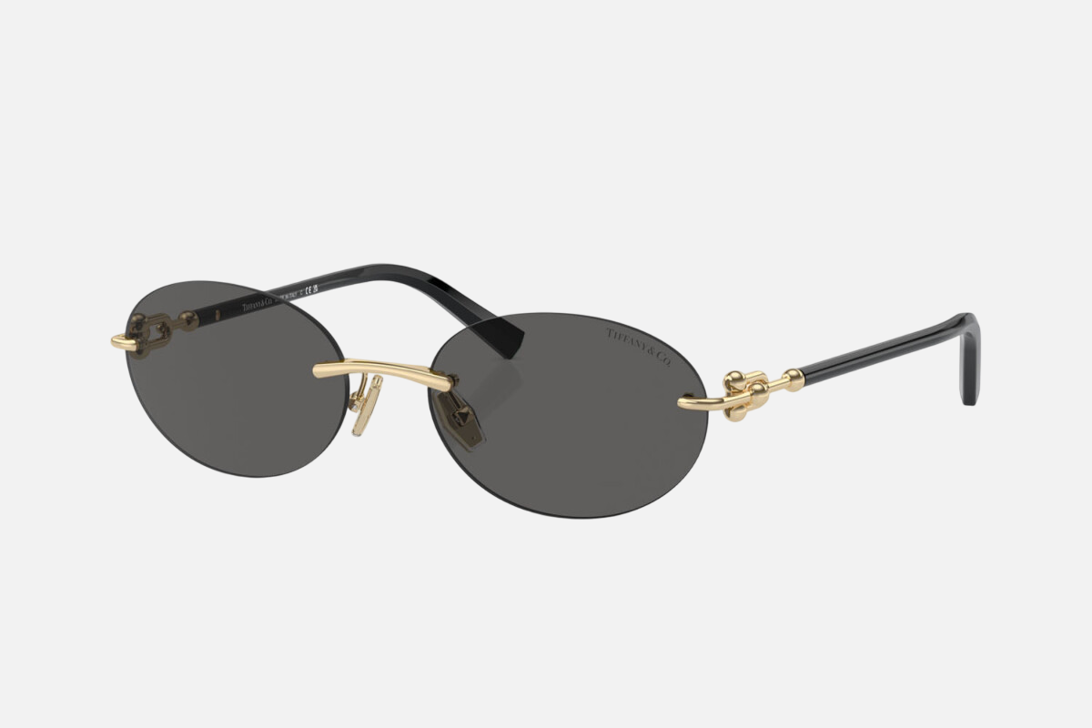 Tiffany TF3104D 6216S4 women's rimless oval sunglasses in a pale gold metal frame with dark grey lenses. Features a 56 mm lens size, 18 mm bridge size, and 140 mm temple length. Available in Dubai, UAE.